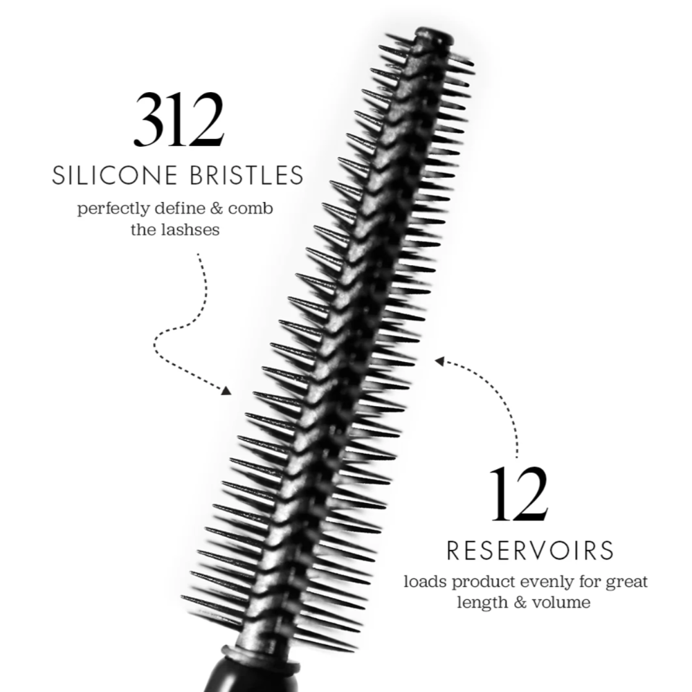 A black round lash comb brush shown on a white background with callout text reading '312 SILICONE BRISTLES' and '12 RESERVOIRS'.