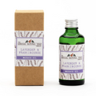 A bottle of lavender and frankincense massage oil next to its brown kraft paper packaging box, both featuring white and purple labels with lavender illustrations. The brand 'The Donegal Natural Soap Company' is clearly visible.