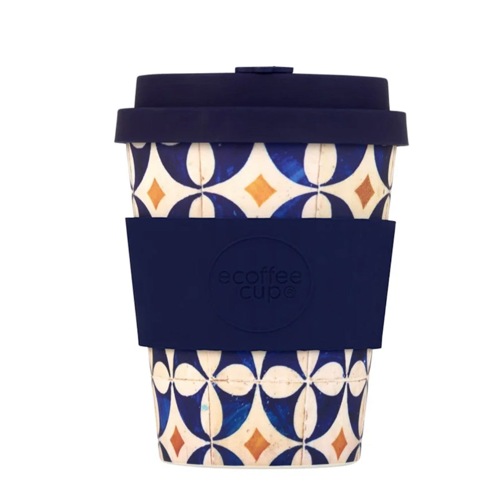 Reusable coffee cup with geometric pattern and navy lid on a white background