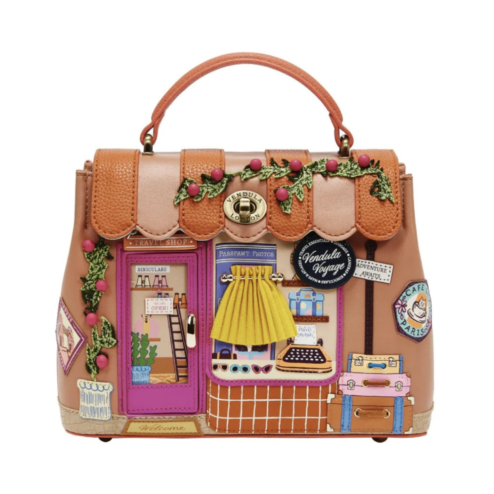 Decorative handbag with miniature scenes and accessories on a white background