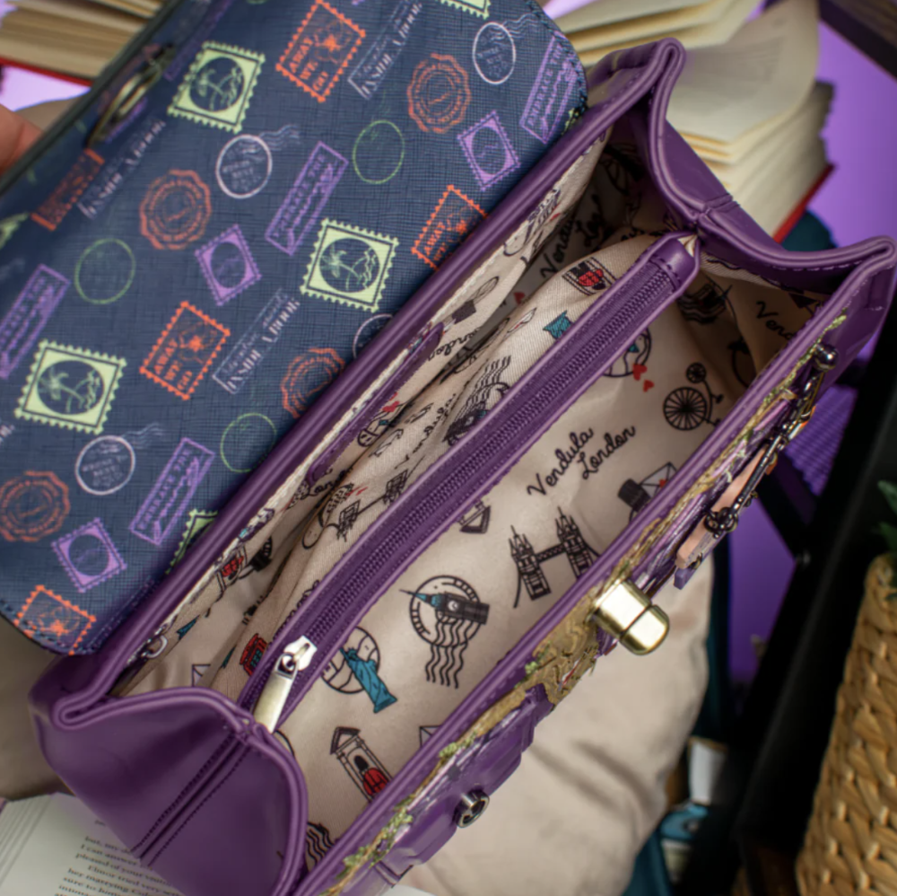 A purple bag shown open, with a cream interior printed with London-themed illustrations and the text 'Vendula London.'
