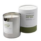 A La Bougie Mission Fig 2016 scented candle in a brushed silver metal tin with a white label, shown next to its white cylindrical cardboard packaging with an olive green base on a white background.