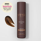 Vita Liberata mousse bottle with brown mousse sample on a light gray background