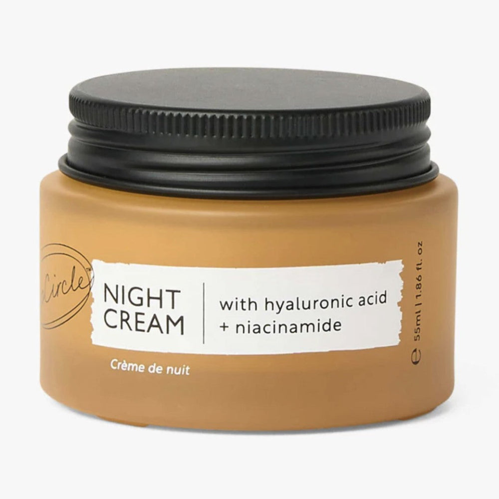 Jar of night cream with black lid on a white background