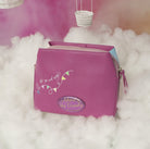 Purple pouch with decorative text and design on a fluffy white surface