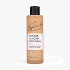 A bottle of UpCircle Powder to Foam Face Wash, featuring a warm tan liquid visible through the clear bottle, a black cap, and a white label with black text.
