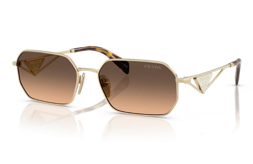 Gold-framed sunglasses with brown gradient lenses on a white background