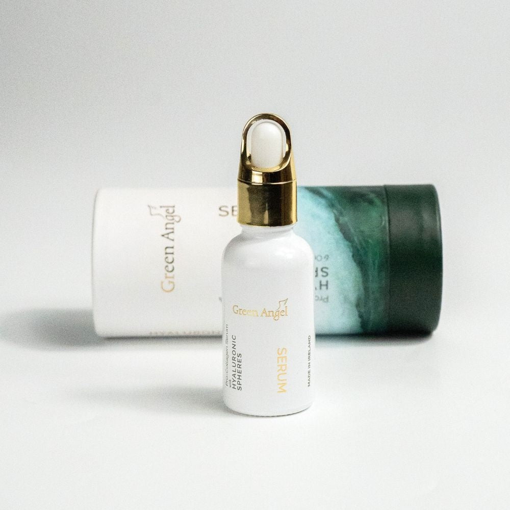 Green Angel skincare serum bottle with gold cap on a light gray background