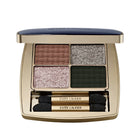 Estée Lauder eyeshadow palette with four colors and two brushes on a light gray background