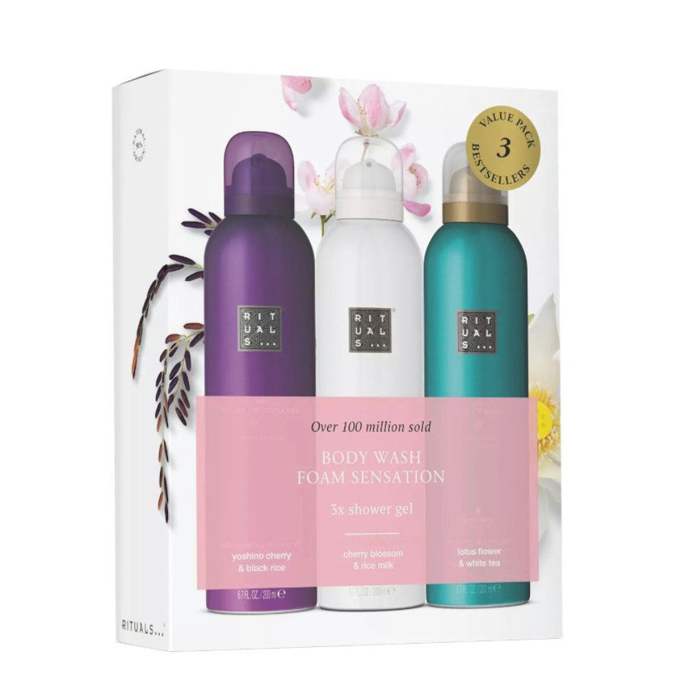 Three bottles of Rituals body care products in a box with floral decorations