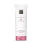 A white squeeze tube of Rituals The Ritual of Sakura hand balm with a pink cap, centered on a clean white background.