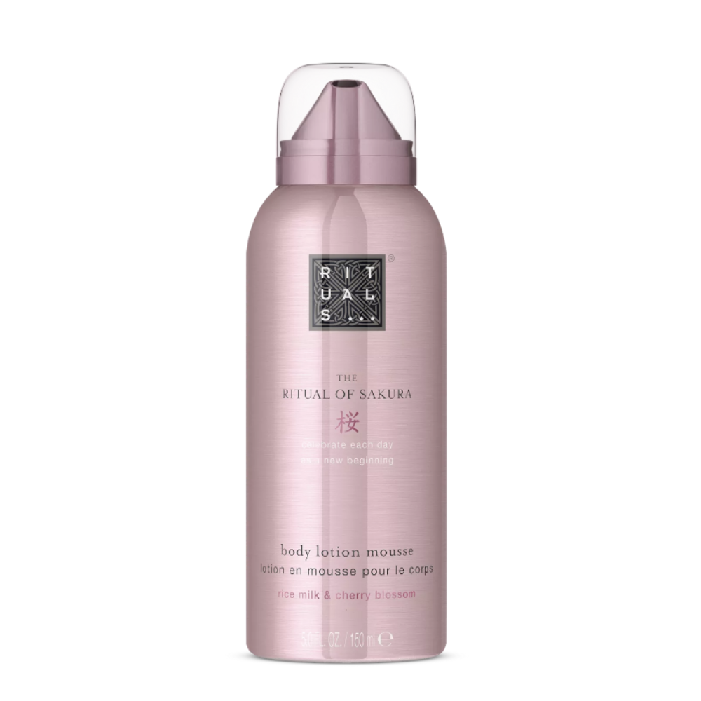 A bottle of Rituals The Ritual of Sakura body lotion in a metallic pink bottle with a clear cap, centered on a white background.