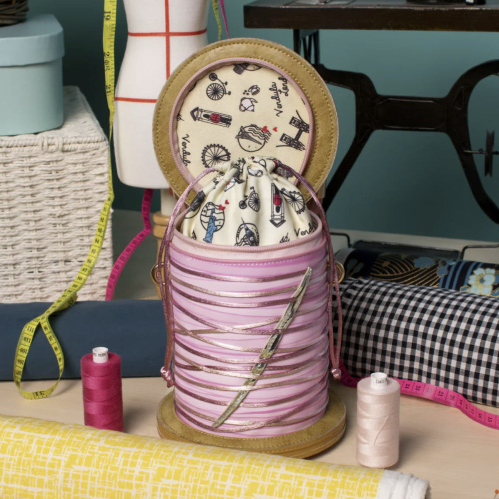 Decorative spool with fabric and sewing accessories on a table