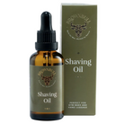 Brownbull Shaving Oil in an amber glass dropper bottle next to its olive green packaging box, on a solid white background.
