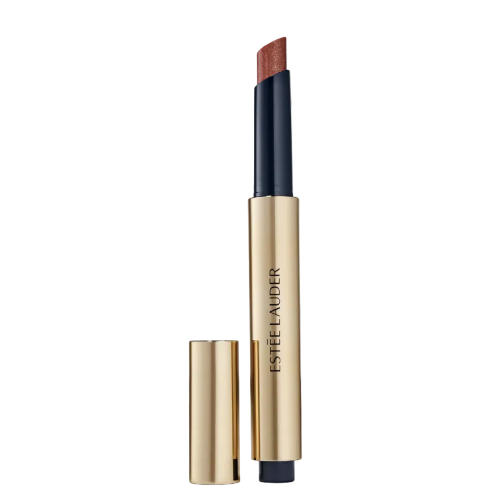 Estee Lauder lipstick in a gold and navy tube with the cap removed, showing a warm brown lipstick bullet, on a light gray background.