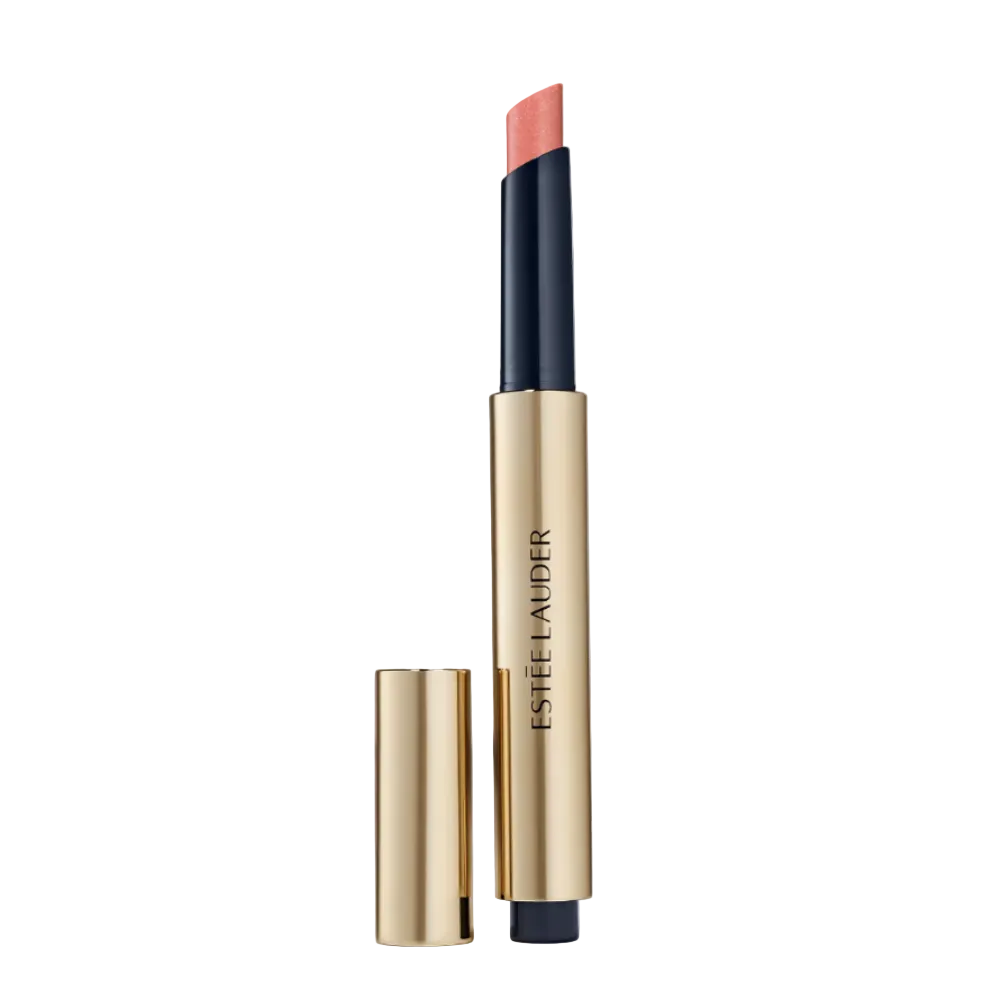 Estée Lauder lipstick in a gold and black tube with the cap off, showing a peachy coral pink lipstick bullet, on a white background.
