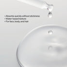 Close-up of a oil droplet being poured onto a white surface with text describing product features.