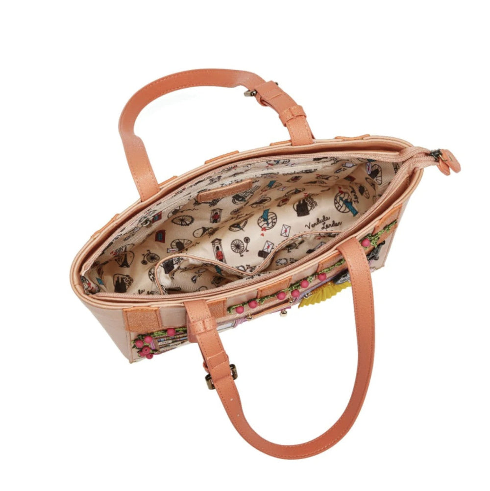 Open handbag with floral patterned interior on a white background