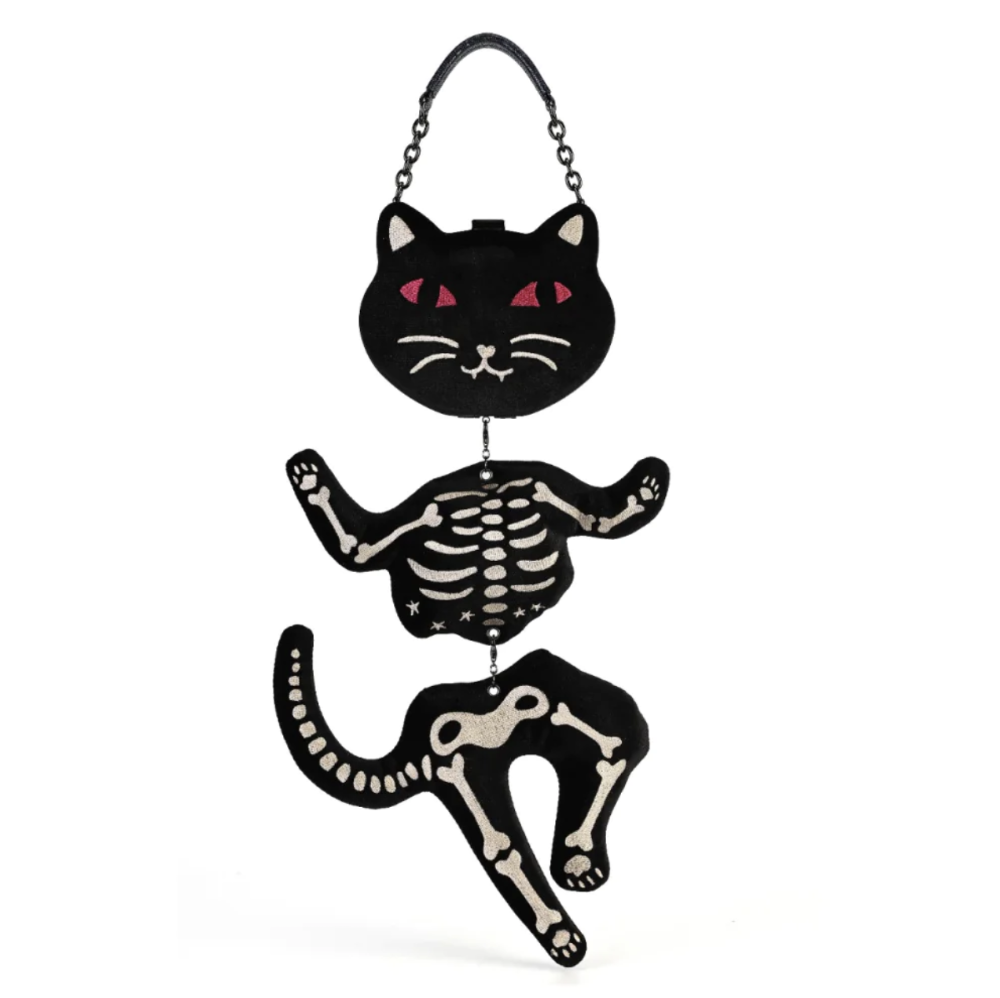 A black cat-shaped purse with a skeleton design, featuring pink eyes and a chain strap, shown on a plain white background.