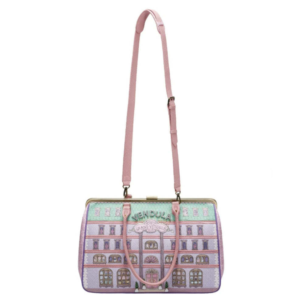 Handbag with architectural design and pink strap on a white background