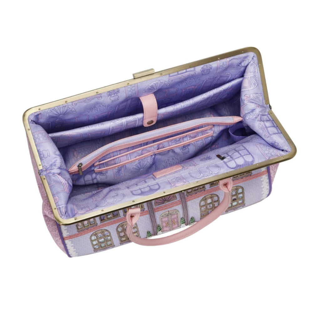 Open fabric suitcase with purple interior and pink handles on a white background