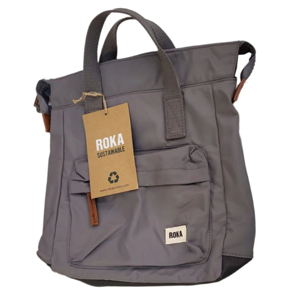 A grey Roka Bantry B recycled nylon small backpack with a front pocket, two side handles, and a vegan pull zipper.