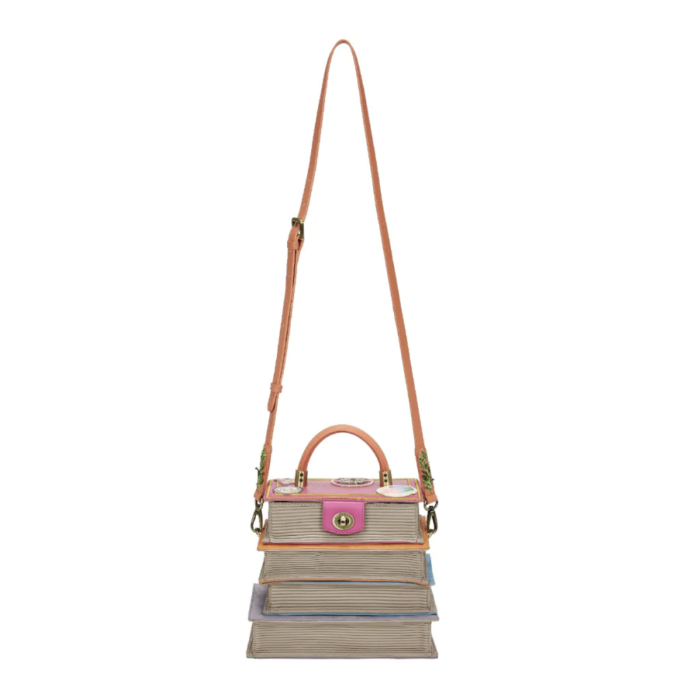 Handbag with a pink top section and brown strap on a white background