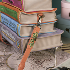 Stack of books with a handbag strap on top, set against a map background