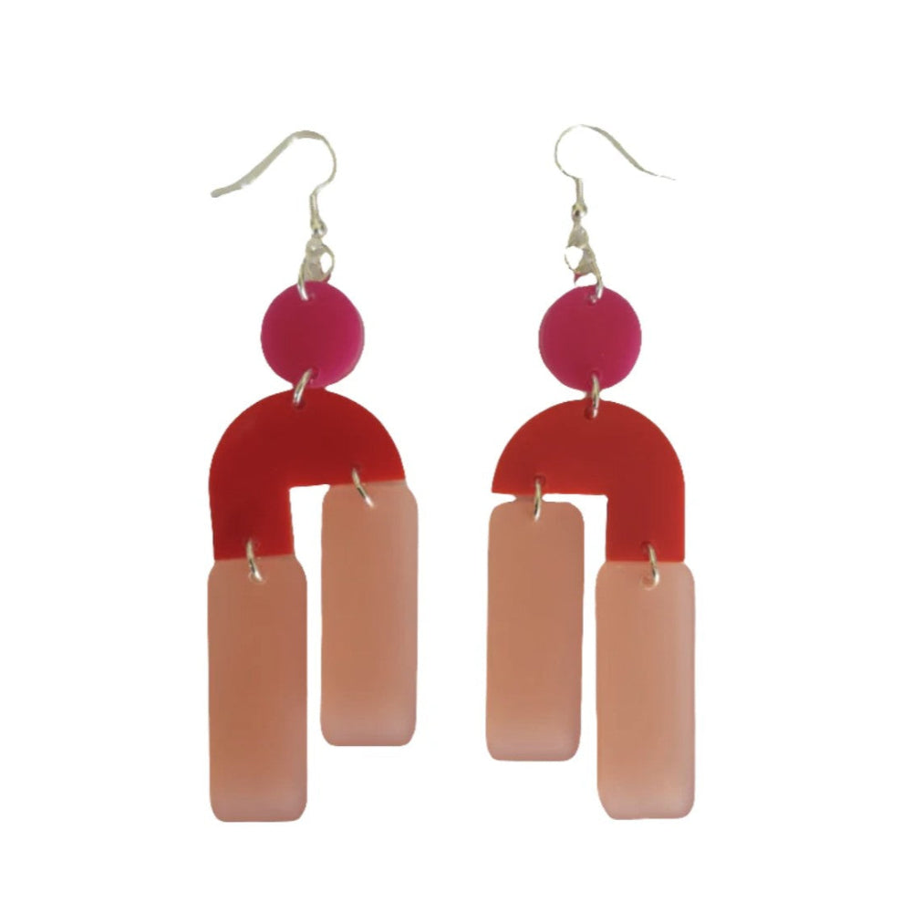 Pair of earrings with pink and red geometric design on a white background