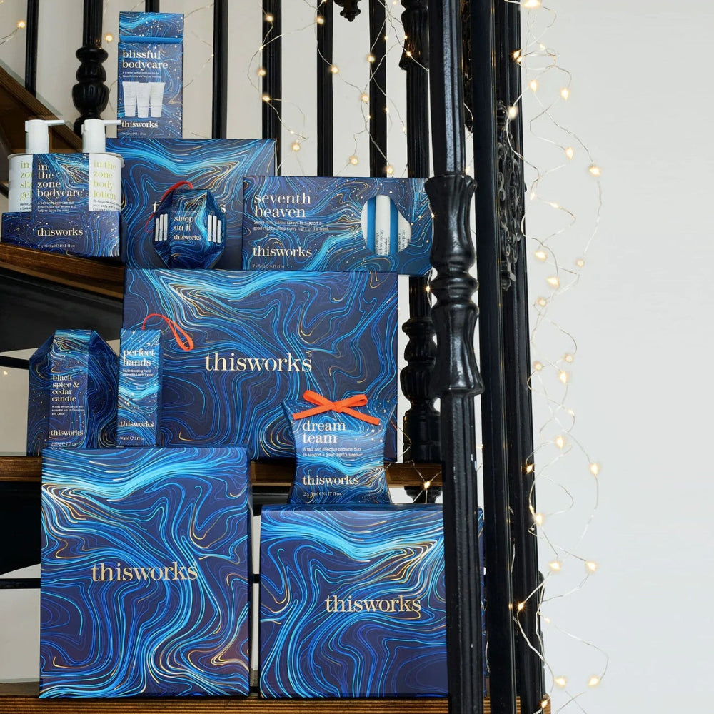 Collection of 'thisworks' product boxes displayed against a decorative background with string lights.