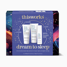 Thisworks Dream to Sleep gift set box featuring three skincare tubes (deep sleep shower gel, deep sleep body cream, and deep sleep sleep aid) on a dark blue background with colorful cosmic illustrations on the side panels.