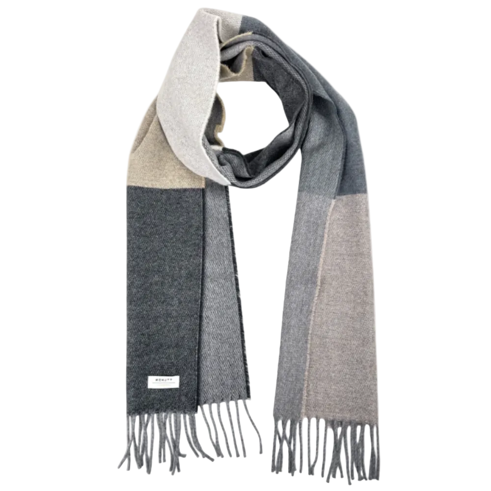 A multi-block color scarf in shades of gray, beige, and charcoal, featuring a fringed hem and a small white brand label that reads 'SARABY'.