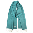 A teal green woven scarf with cream fringe ends and a small white brand label, displayed against a solid white background.