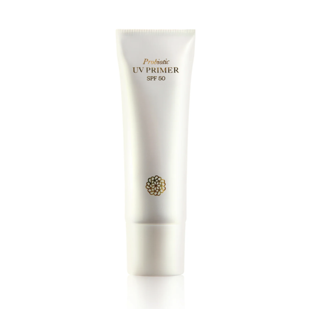 A white squeeze tube of Probiotic UV Primer SPF 50, featuring gold text and a small gold circular pattern on the front, set against a solid white background with a soft reflection below.
