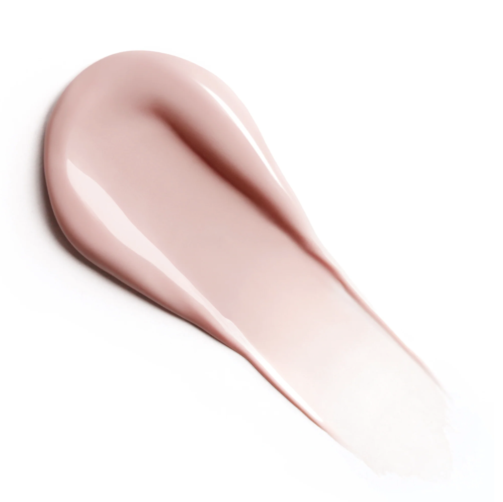A smooth, glossy smear of pale pink primer on a clean white background.