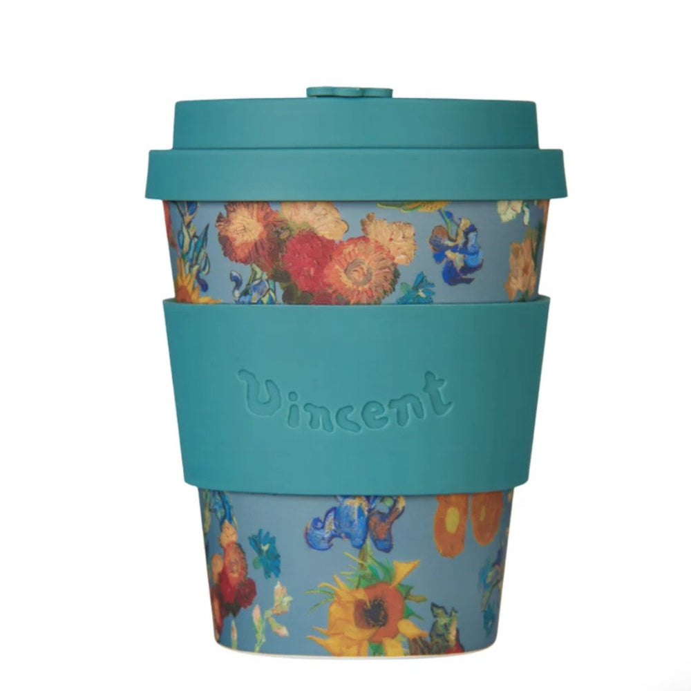 Reusable coffee cup with floral design and teal lid on a white background