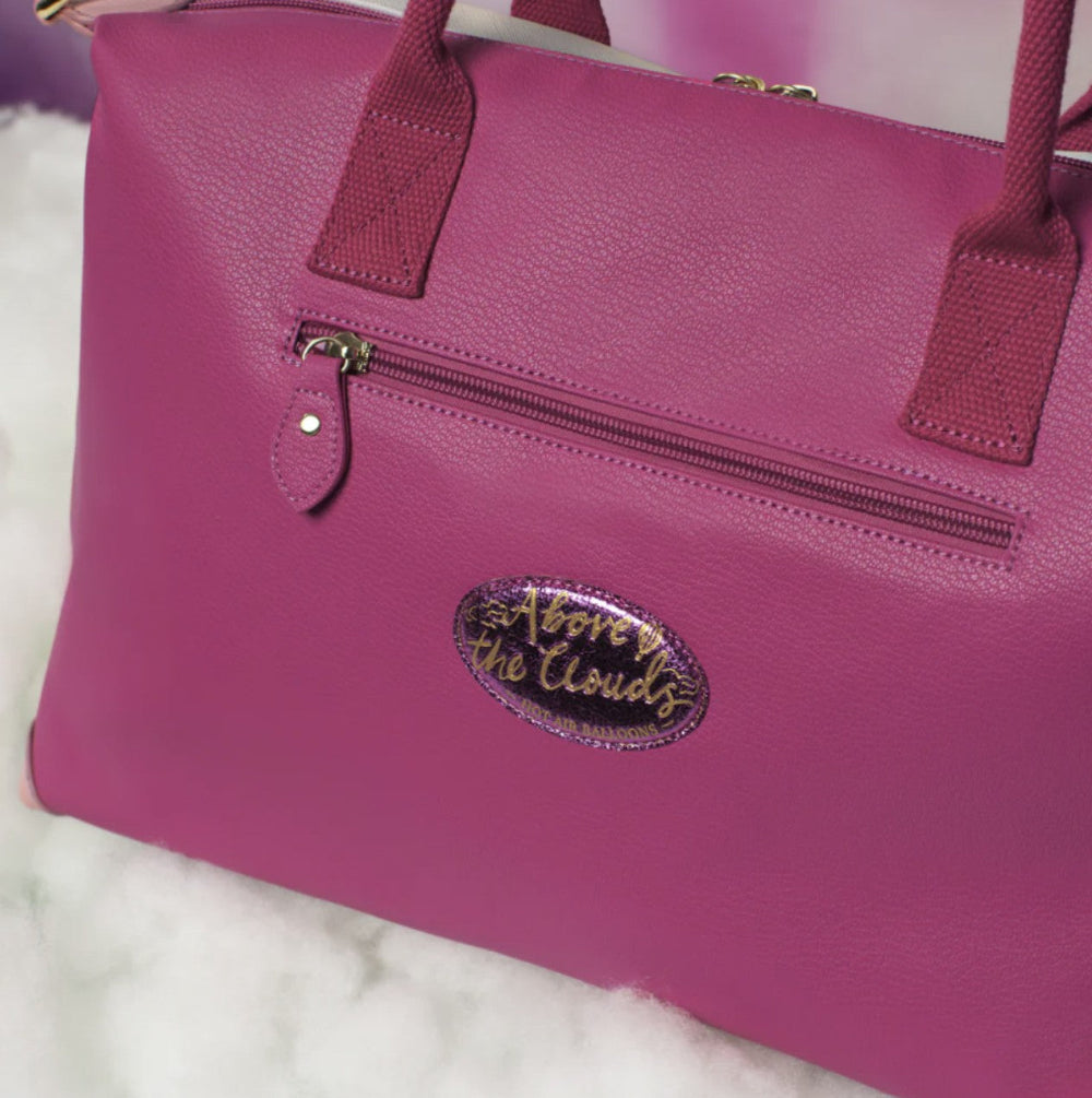 Purple handbag with a visible brand logo on a light background