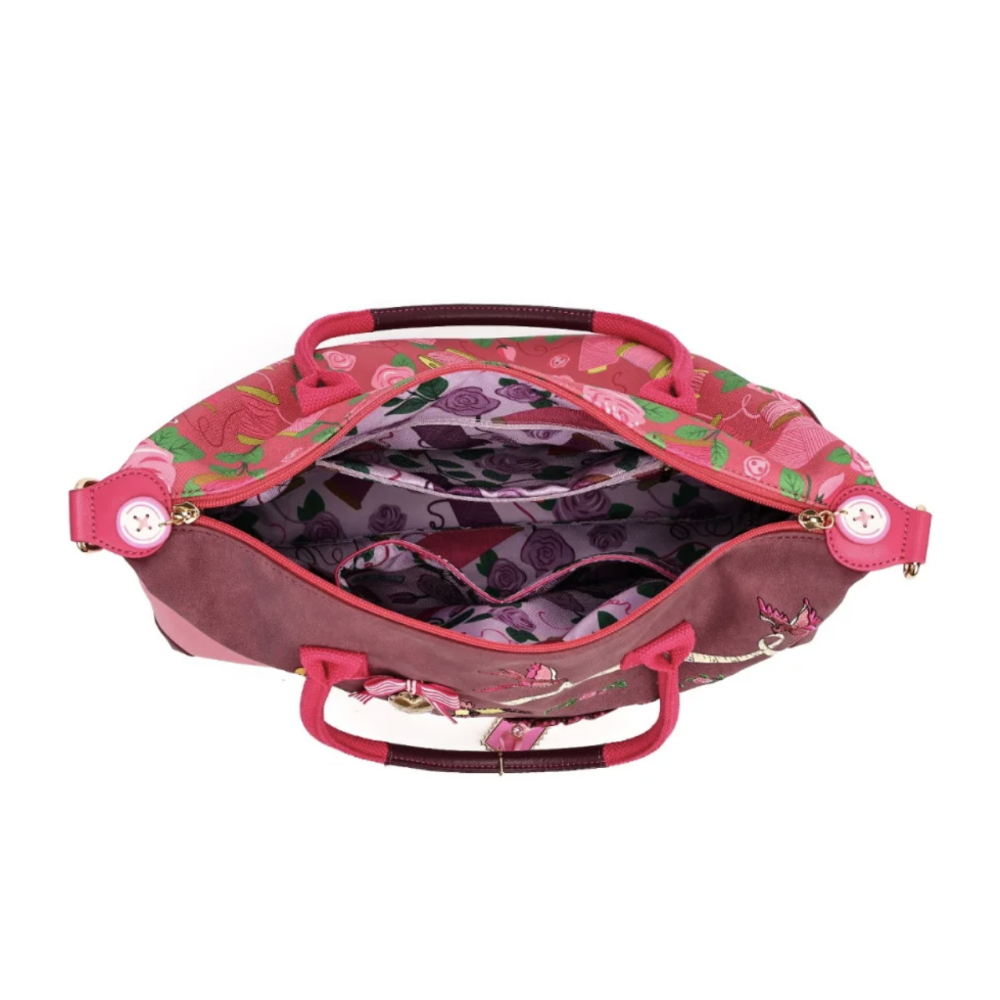 An open pink and purple floral tote bag with pink handles, gold-tone hardware, and a patterned interior organiser, shown on a white background.