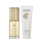 Two Estée Lauder products, a bottle and a tube, on a light gray background.