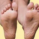 Close-up of two pairs of feet with a yellow background