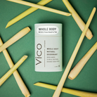 Vico deodorant container on a green background with bamboo sticks