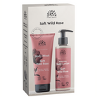 Nordic Beauty Soft Wild Rose body wash and emollient body lotion set in its original packaging box, featuring pink tubes and bottles with black pumps on a beige background.