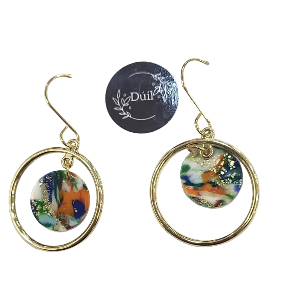 Pair of earrings on a Duil branded card with a white background