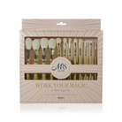A boxed makeup brush set on a white background. The package is a rectangular clear-front case with a beige and blush pink sunburst design, gold lettering reading 'WORK YOUR MAGIC,' and a central circular logo that says 'Mrs. Glam'.