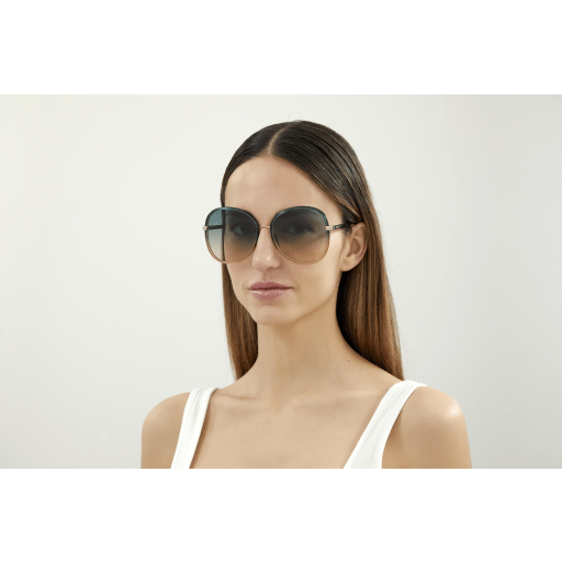 Girl wearing a pair of Balenciaga green sunglasses