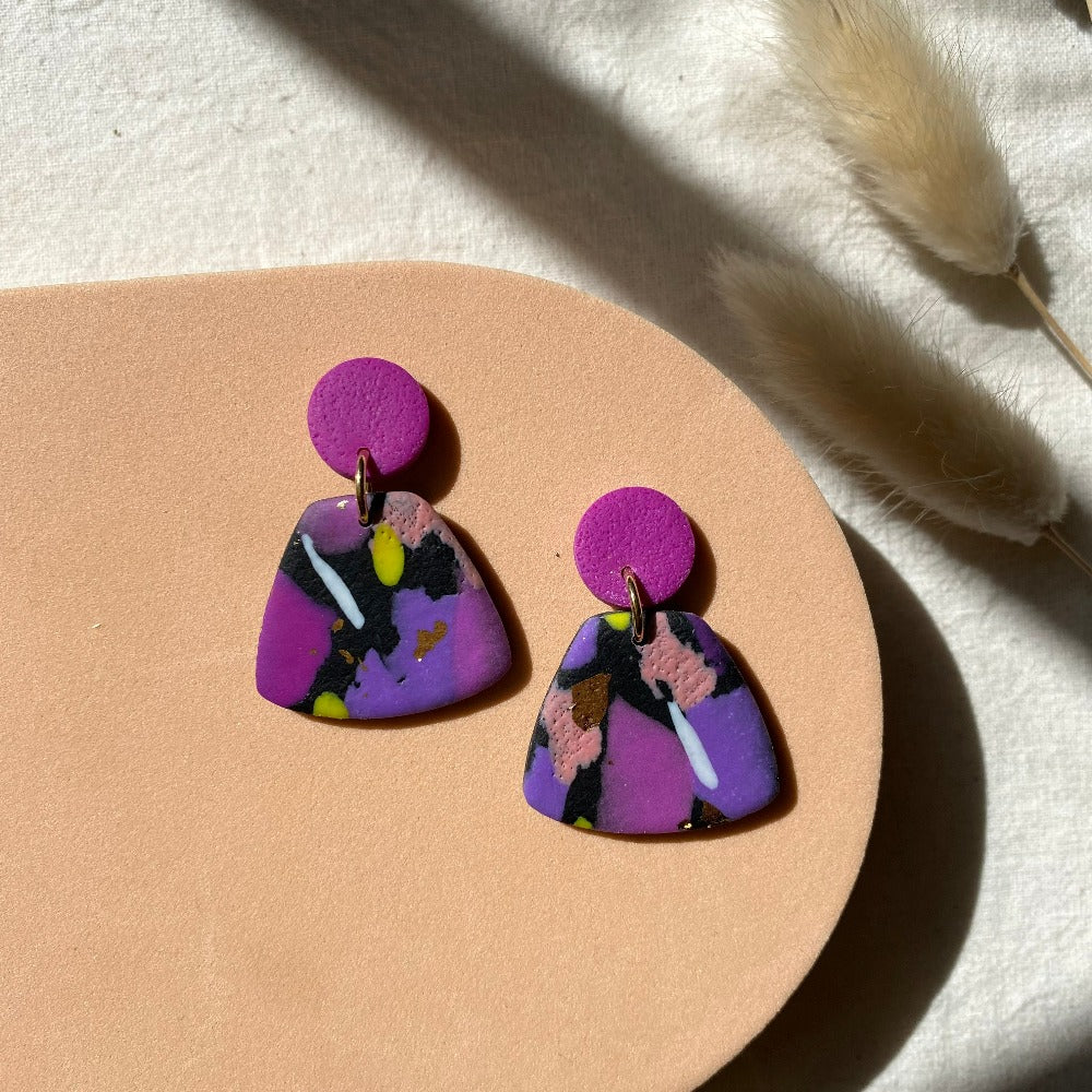 Love Kiki Designs - Medium Dangle Earrings - purple pink on post with purple, pink, peach, black and specs of lime green on clay dangle earrings